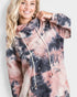 Person wearing a tie-dye hoodie with a plain background