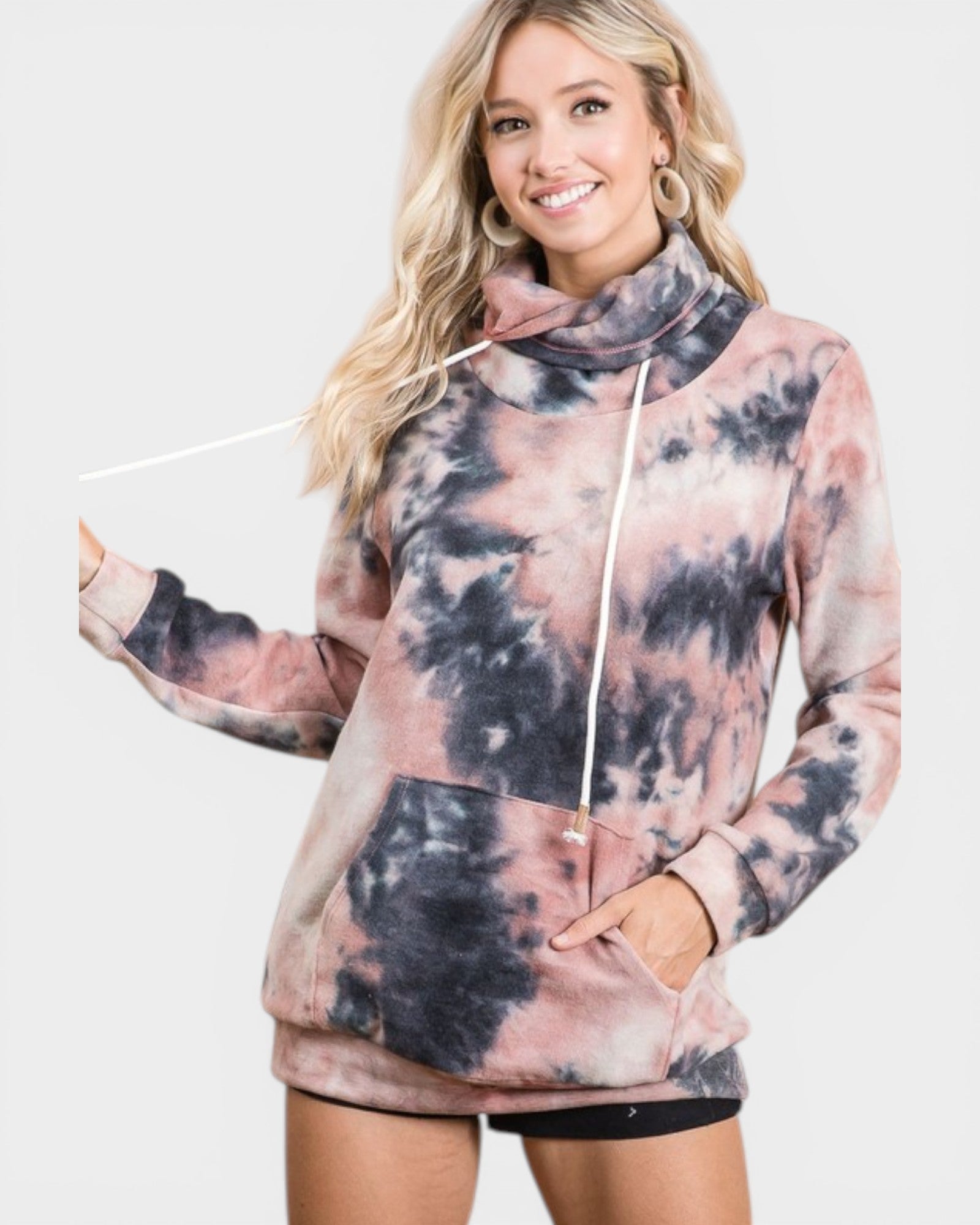Woman wearing a tie-dye hoodie with a plain background