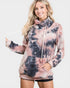Woman wearing a tie-dye hoodie with a plain background