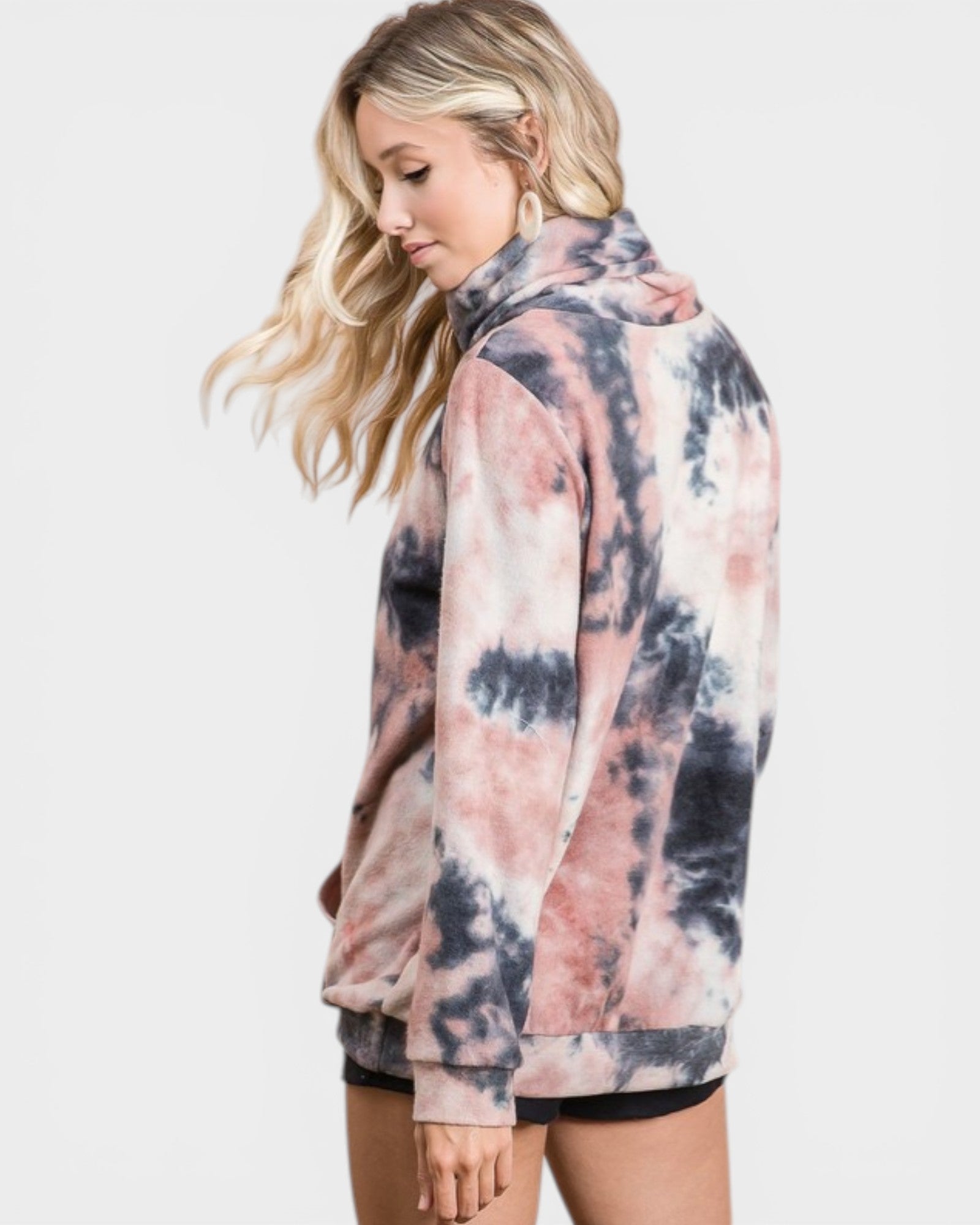 Woman wearing a tie-dye hoodie on a white background