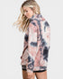 Woman wearing a tie-dye hoodie on a white background