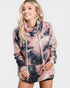 Woman wearing a tie-dye hoodie dress on a white background