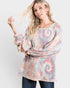 Woman wearing a tie-dye long-sleeve top on a white background