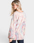 Woman wearing a tie-dye long-sleeve top on a white background
