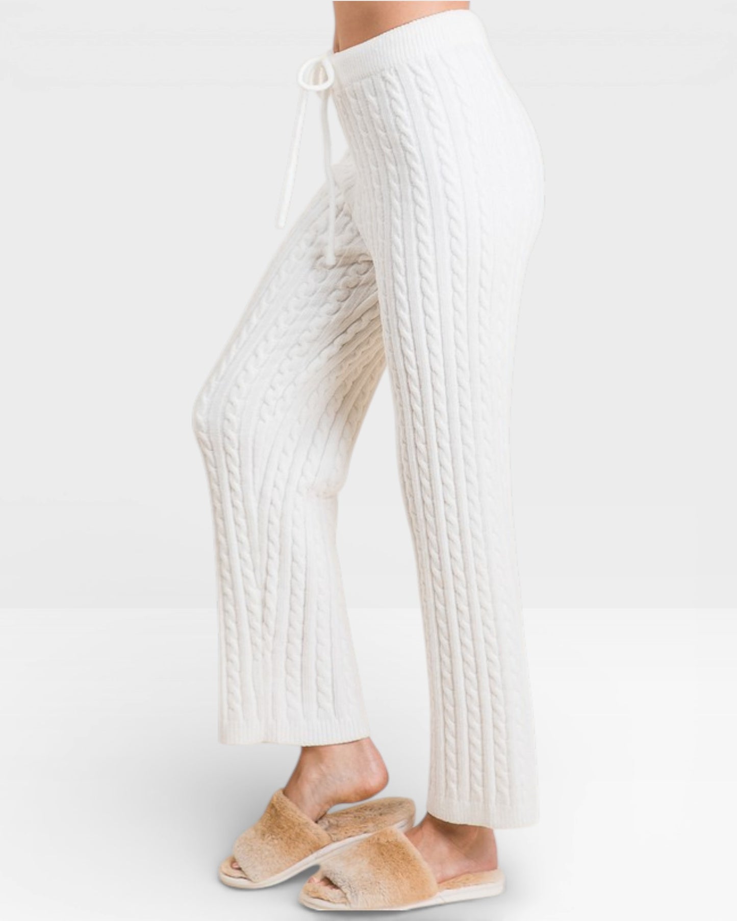 White ribbed pants worn by a person on a white background