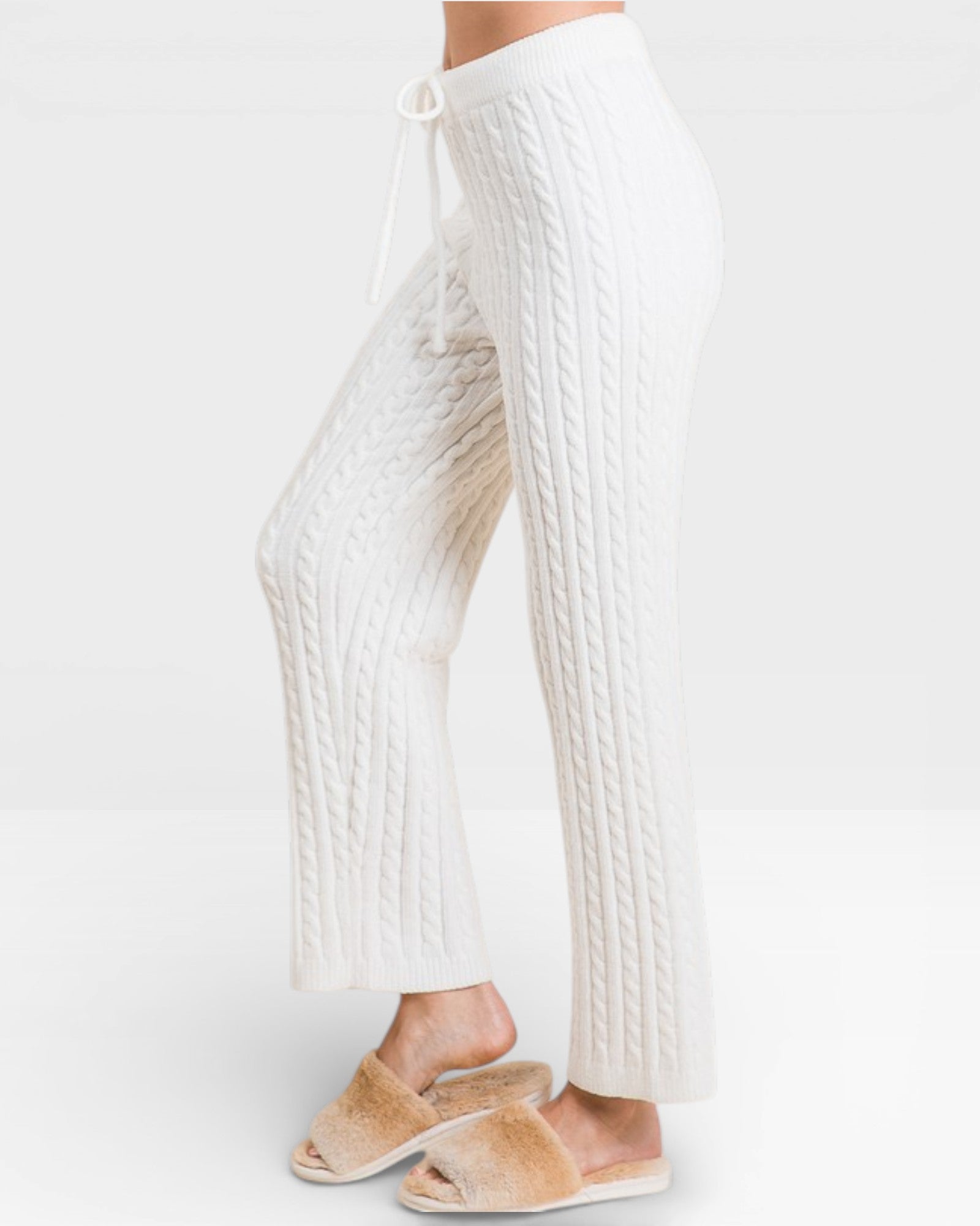 White ribbed pants worn by a person on a white background