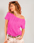 Woman wearing a pink off-shoulder top against a plain background