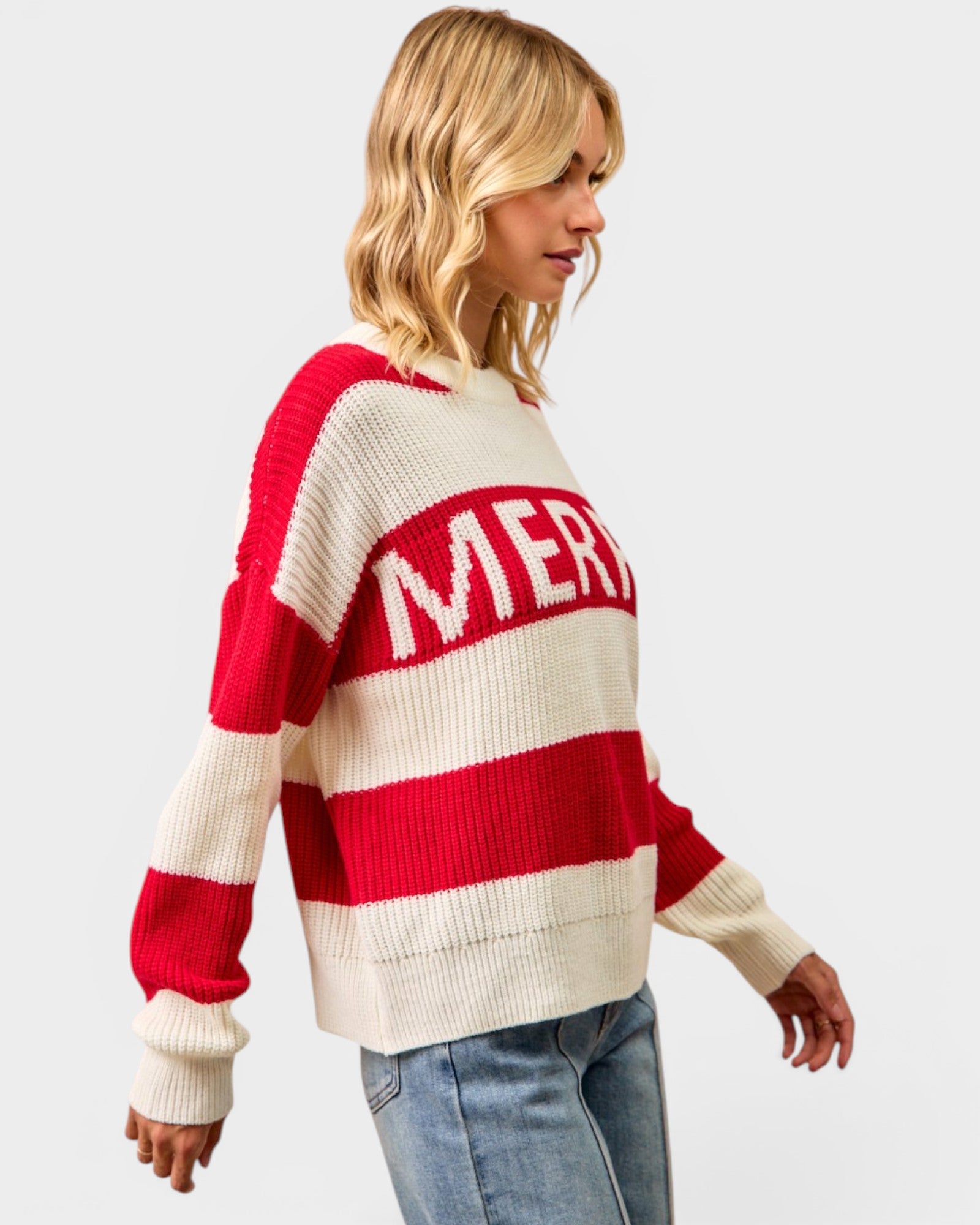 Woman wearing a red and white striped sweater with 'MERRY' text on a light gray background
