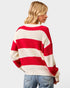 Person wearing a red and white striped sweater on a plain background