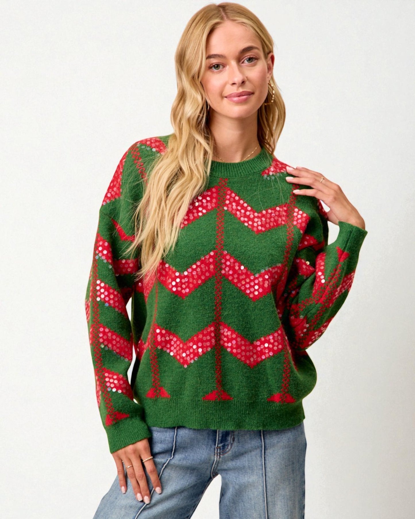 Woman wearing a green and red patterned sweater on a white background
