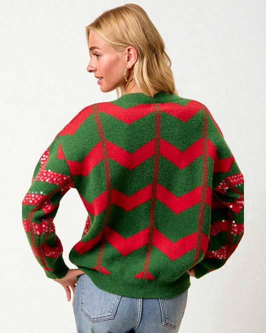 Person wearing a green and red chevron pattern sweater on a white background