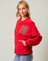 Person wearing a red jacket with a plaid pocket on a plain background