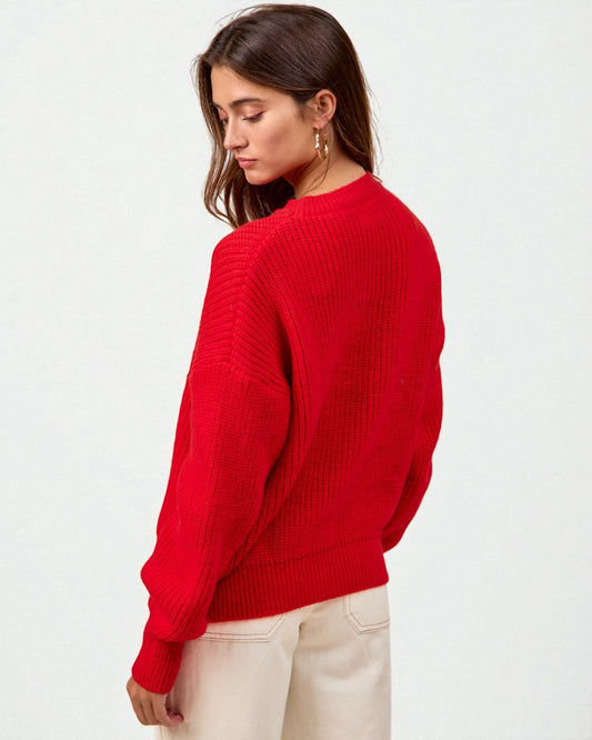 Woman wearing a red sweater on a white background