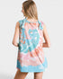 Woman wearing a tie-dye dress with pink and blue patterns on a white background