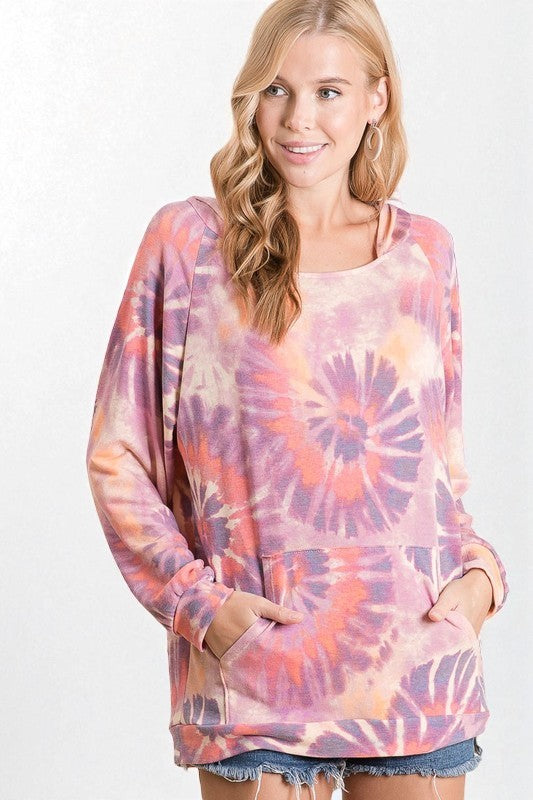 Woman wearing a tie-dye long-sleeve top on a white background