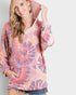 Woman wearing a tie-dye hoodie with a plain background