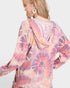 Woman wearing a tie-dye hoodie with a white background