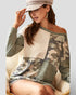 Woman wearing a camouflage-patterned dress with a neutral background