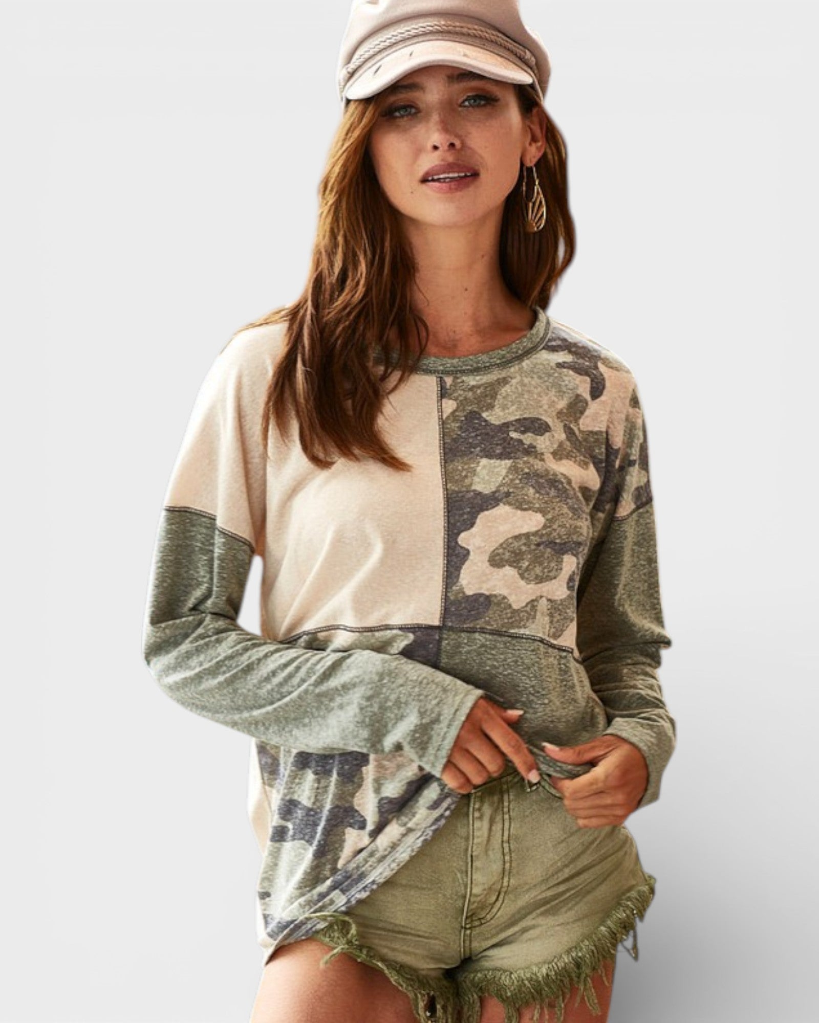 Woman wearing a camouflage and beige long-sleeve shirt with shorts on a white background