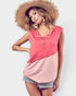 Woman wearing a pink sleeveless top and straw hat on a white background