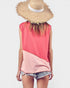 Person wearing a pink and coral sleeveless top with denim shorts and a straw hat on a white background