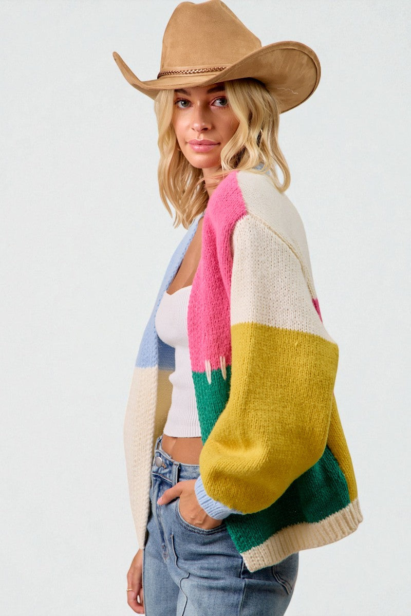 Woman wearing a colorful cardigan with a white background