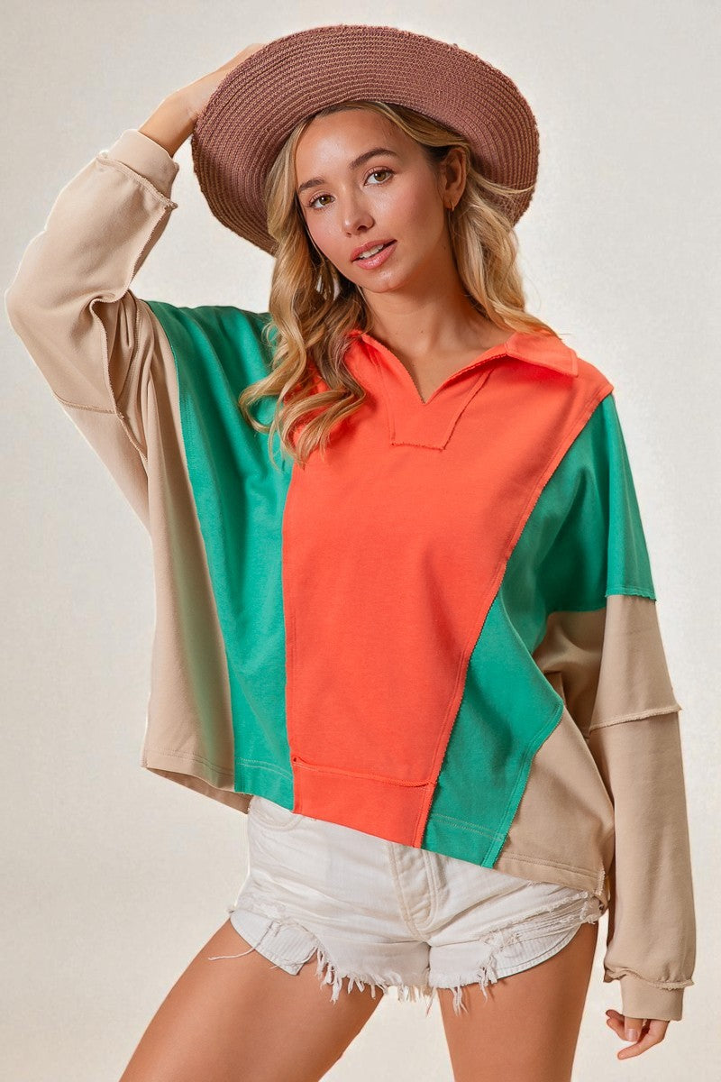 Woman wearing a colorful sweater with a neutral background