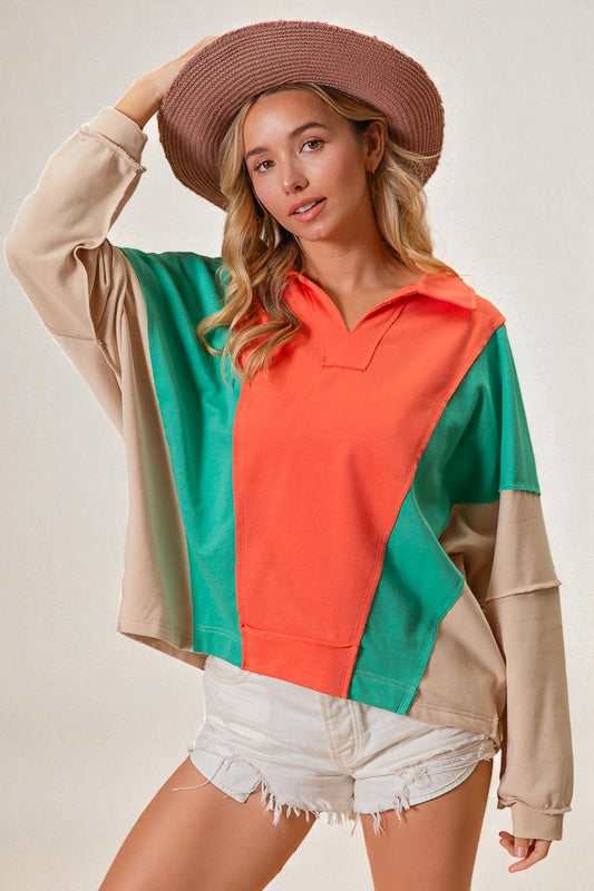 Woman wearing a colorful sweater with a neutral background