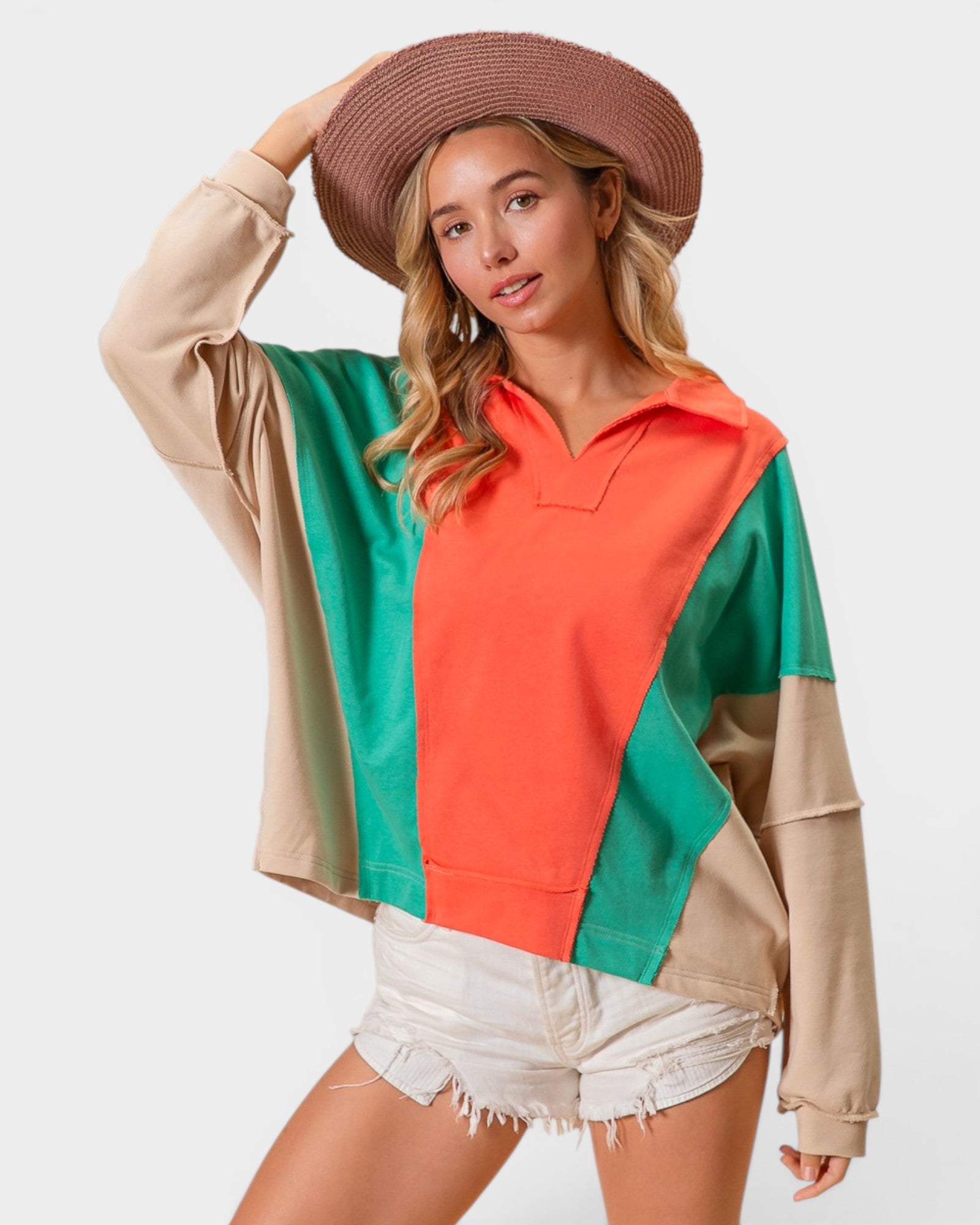 Woman wearing a colorful sweater with a plain background