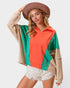Woman wearing a colorful sweater with a plain background
