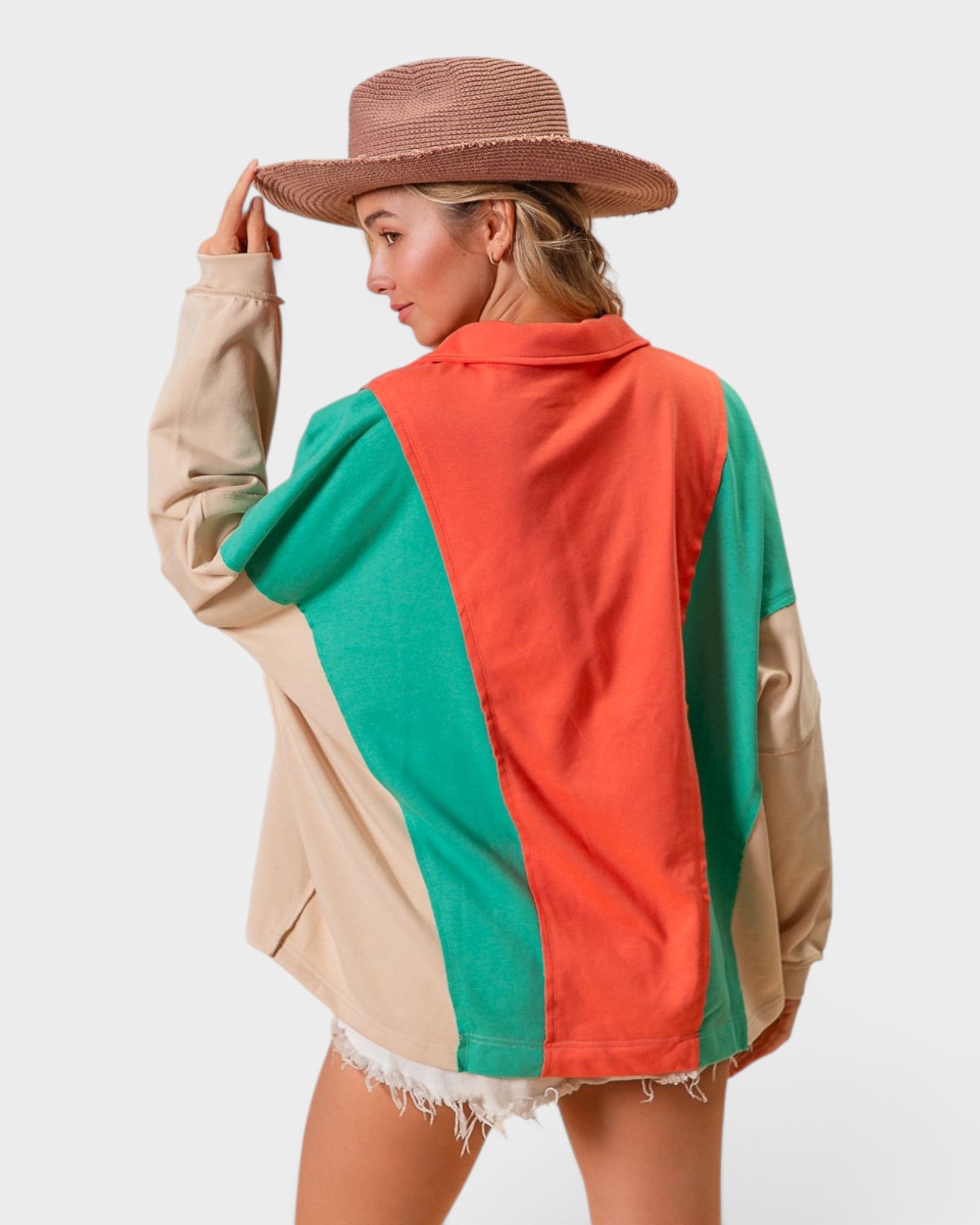 Person wearing a colorful jacket with a neutral background