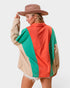 Person wearing a colorful jacket with a neutral background