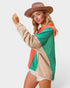 Woman wearing a colorful jacket with a plain background