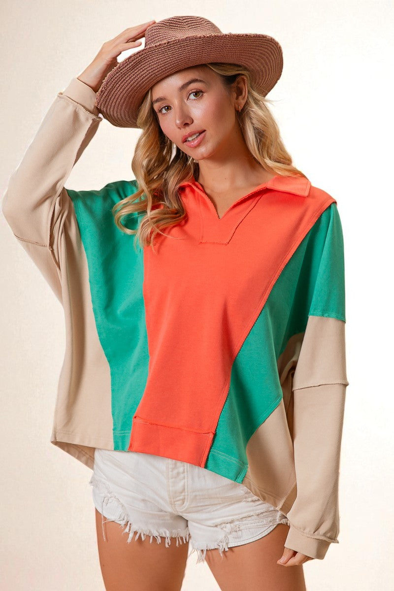 Woman wearing a colorful sweater with a beige hat and white shorts on a beige background