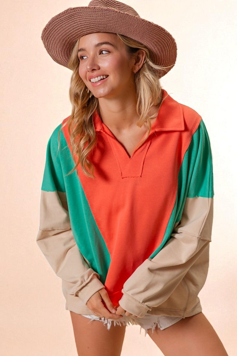 Woman wearing a colorful outfit with a pink hat on a beige background