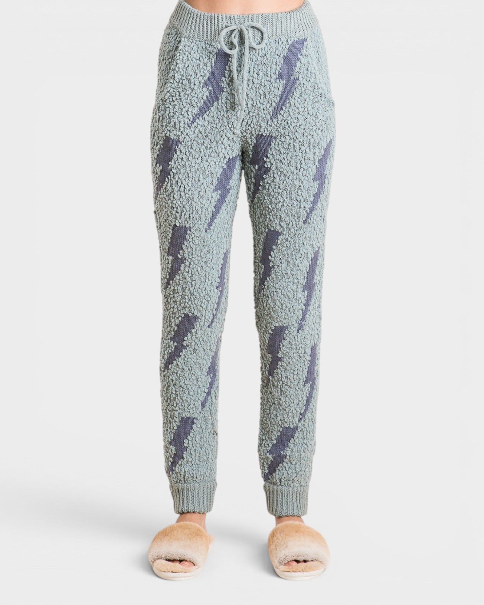 Light blue jogger pants with dark blue lightning bolt pattern on a white background