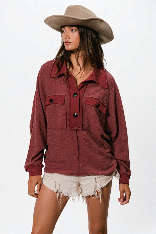 Woman wearing a red shirt and beige cowboy hat on a white background