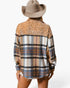 A woman shown from the back wearing a long-sleeve plaid shirt with leopard-print sequin detailing across the shoulders and a tan cowboy hat against a plain white background.