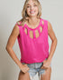 Woman wearing a bright pink sleeveless top with cut-out details on a plain background