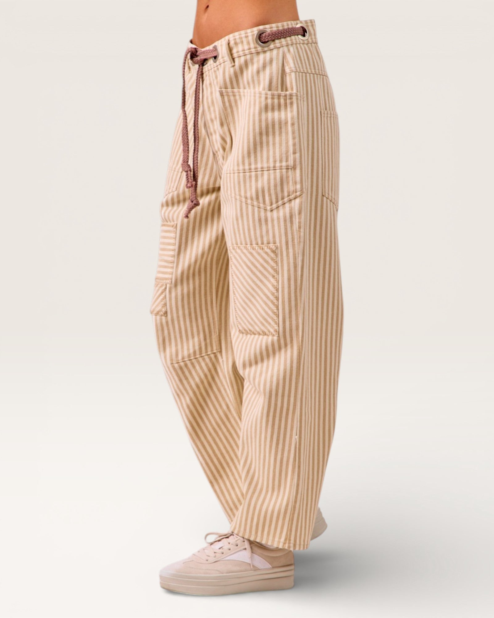 Beige striped pants worn by a person on a white background