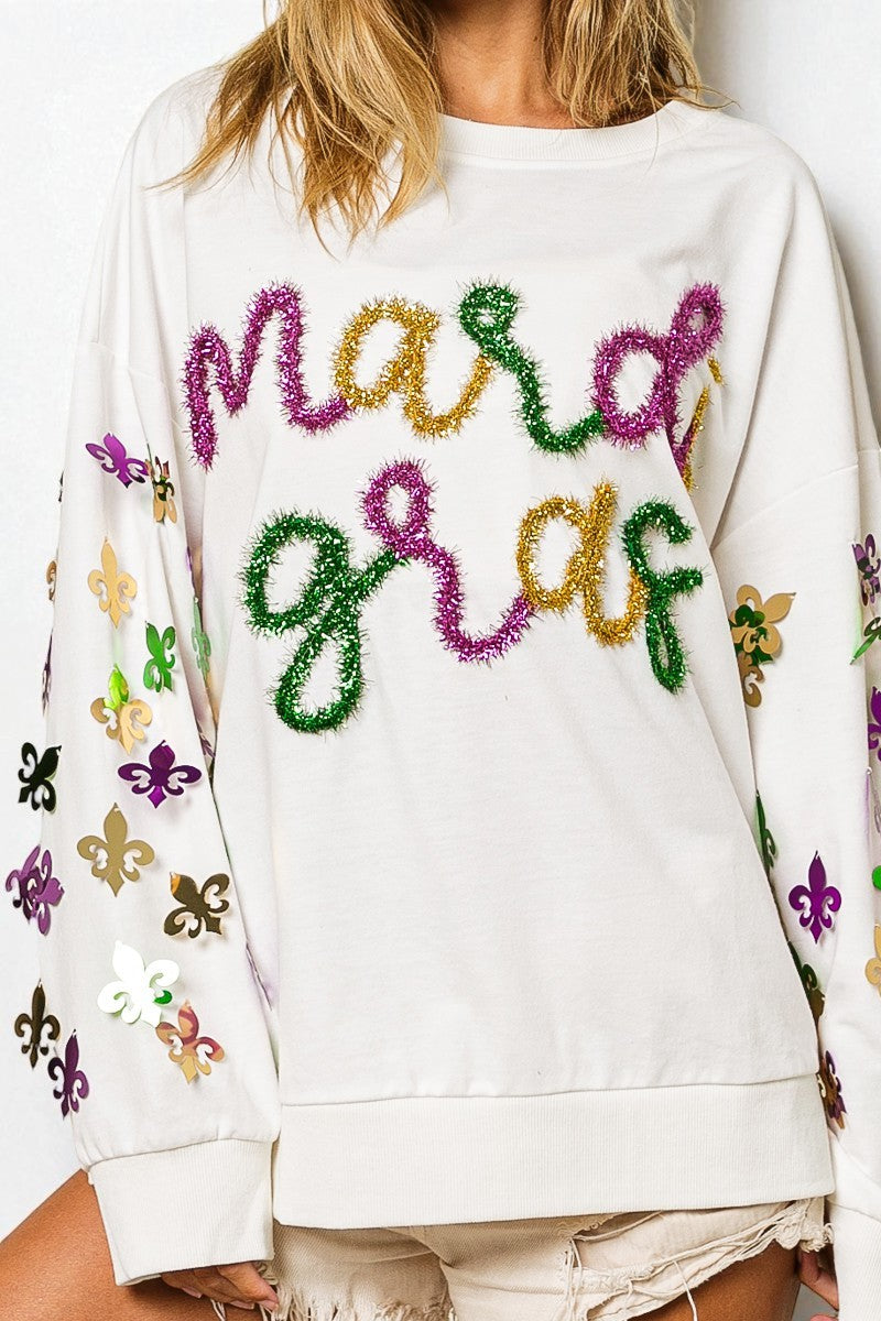 White sweatshirt with colorful text and patterns on a plain background