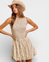 Woman wearing a floral dress and straw hat on a plain background