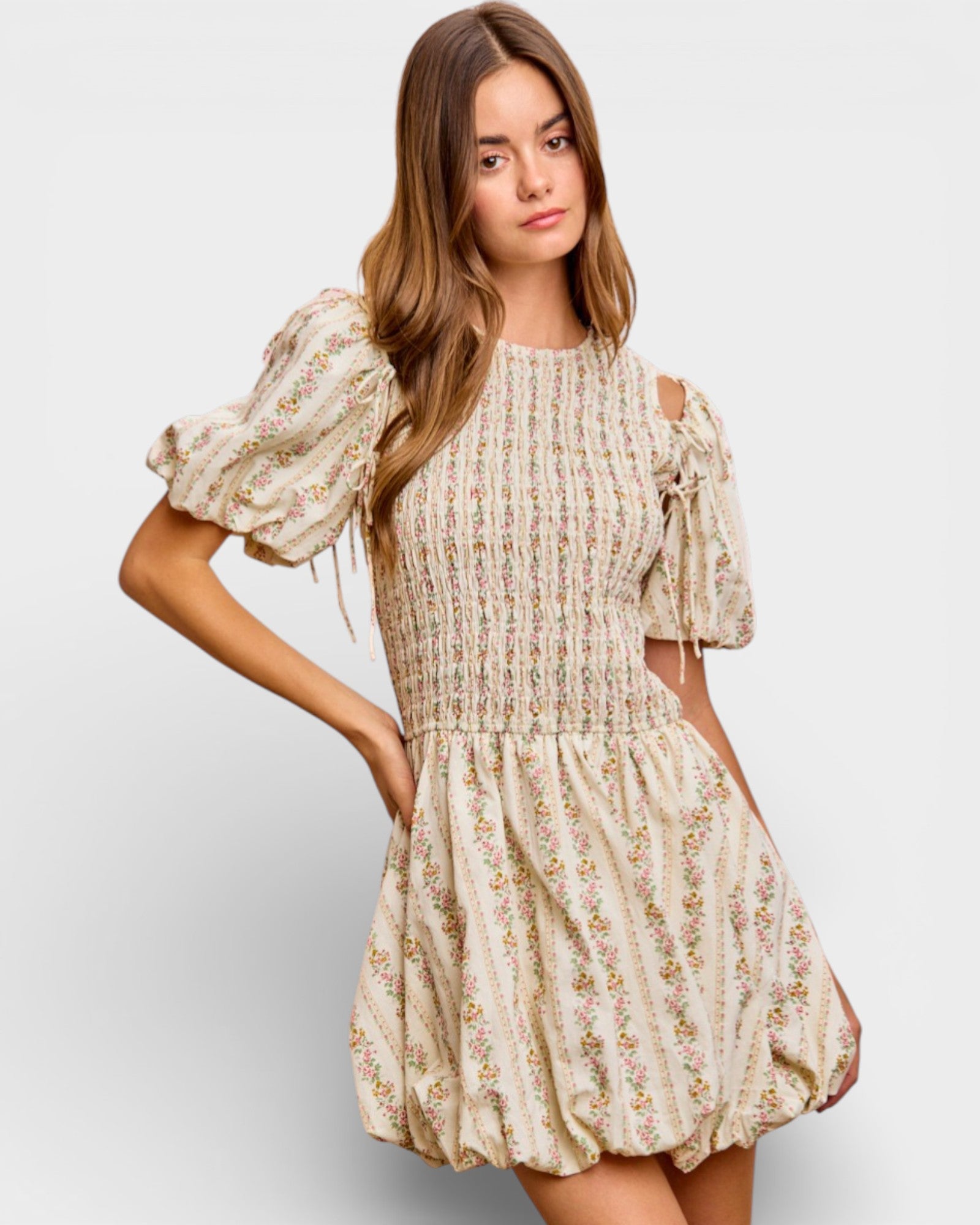 Woman wearing a floral dress on a plain background
