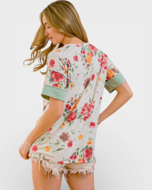 Woman wearing a floral kimono-style garment on a white background