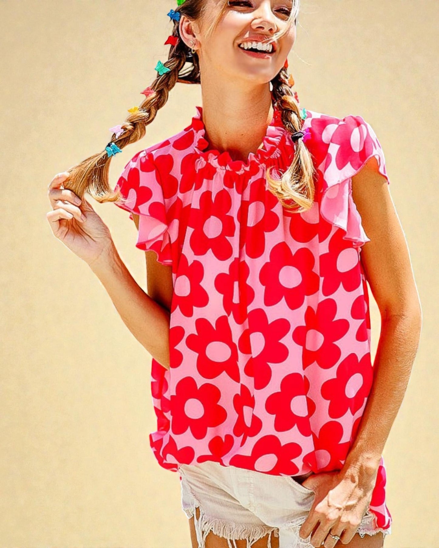 Girl wearing a pink floral top against a beige background