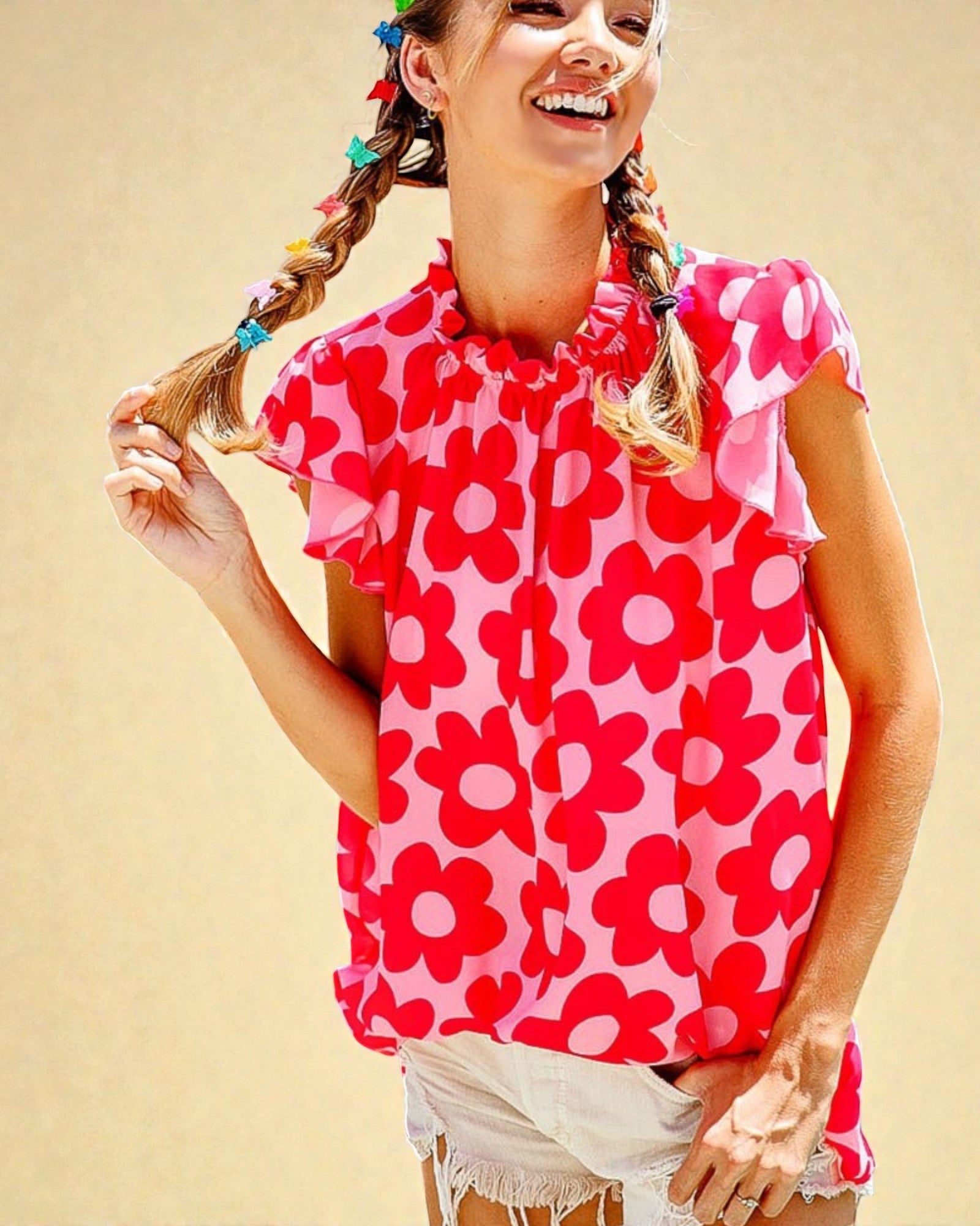 Girl wearing a pink floral top against a beige background