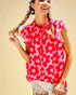 Girl wearing a pink floral top against a beige background