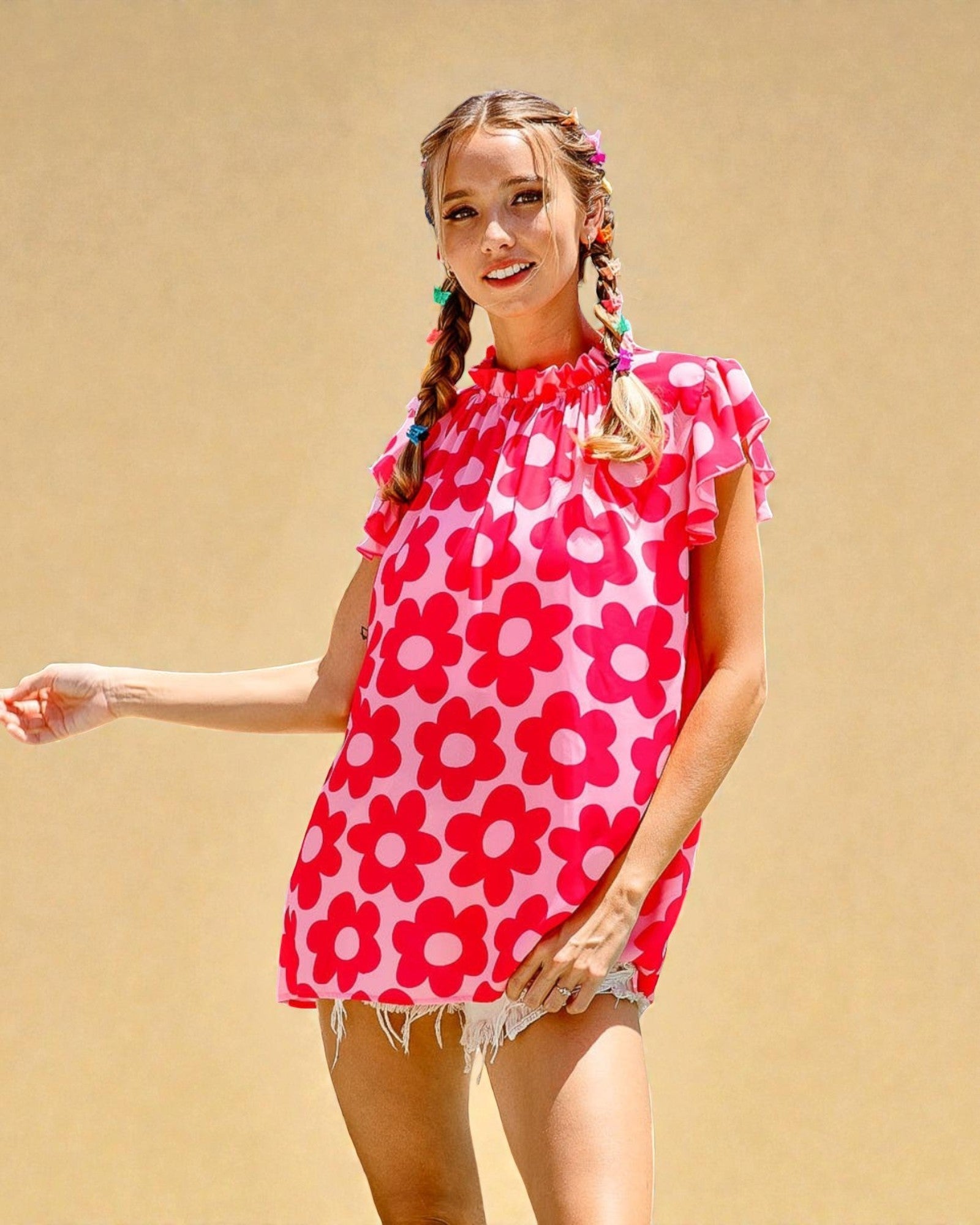 Woman wearing a pink floral dress against a beige background