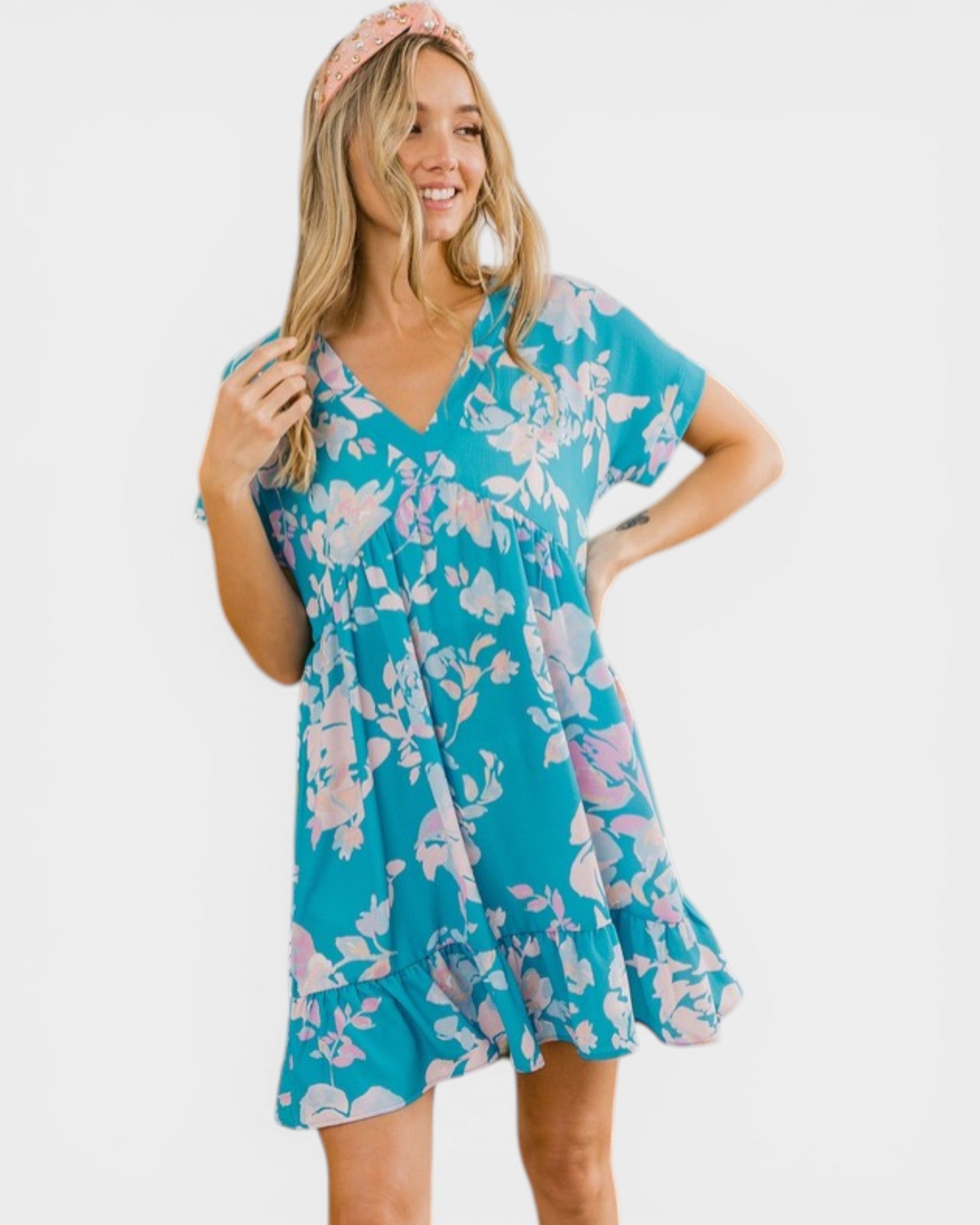 Woman wearing a blue floral dress on a white background