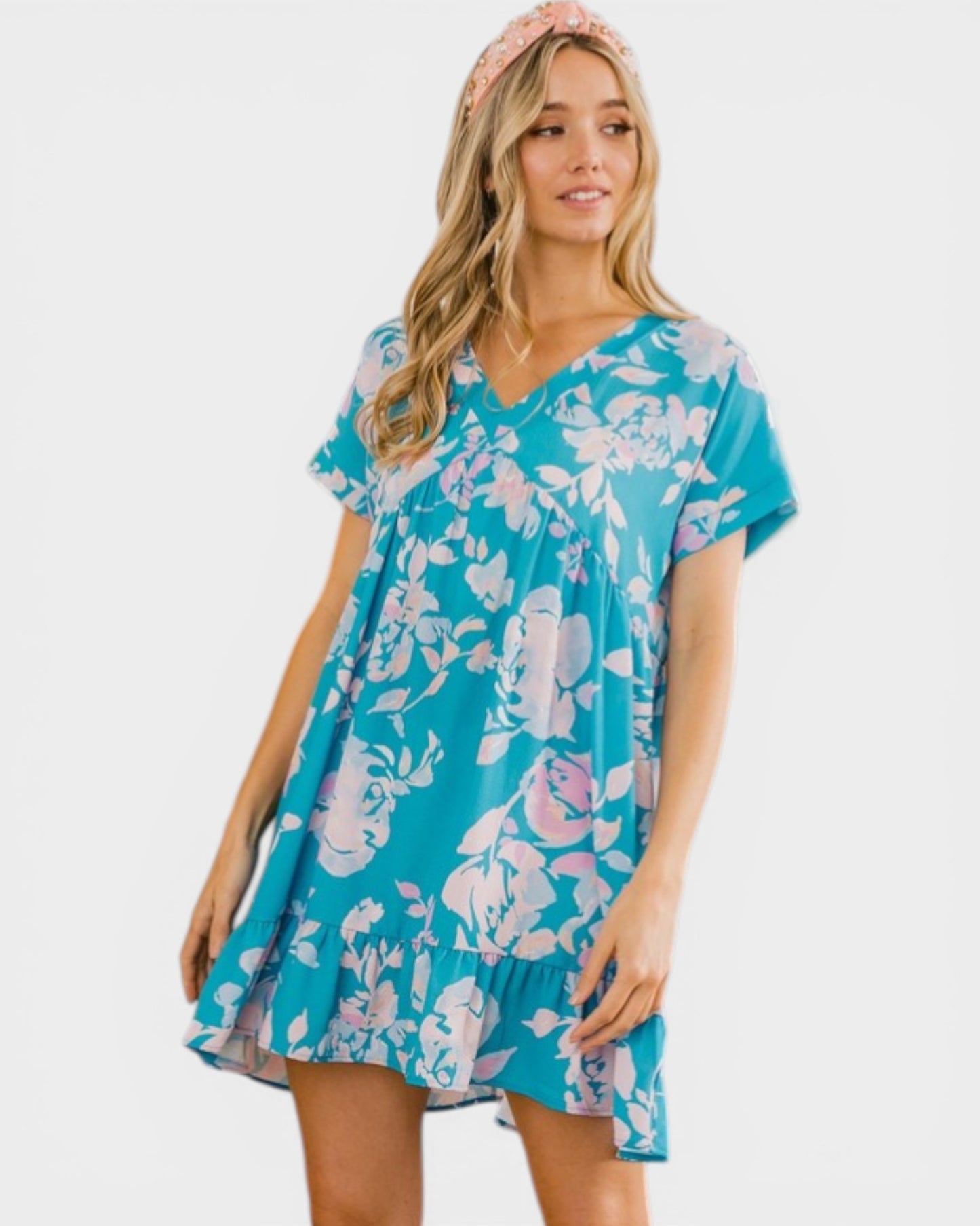 Woman wearing a blue floral dress on a white background